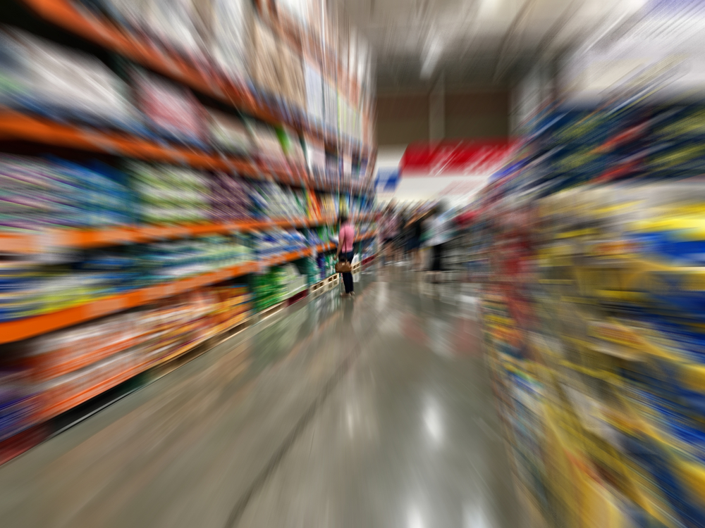 Blurry motion image of a woman shopping in a wearhouse